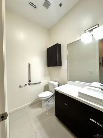 a bathroom with a toilet a sink and mirror