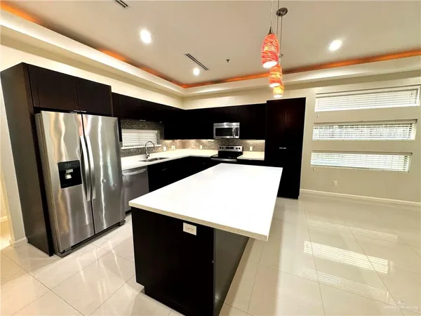 a kitchen with stainless steel appliances a refrigerator and a sink