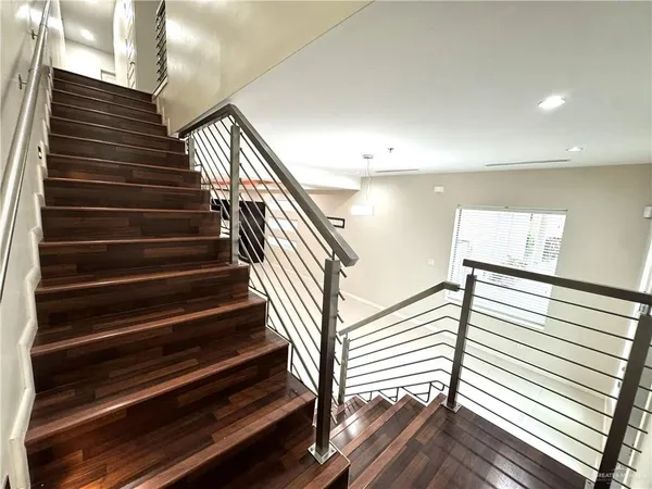 a view of entryway and hall with wooden floor