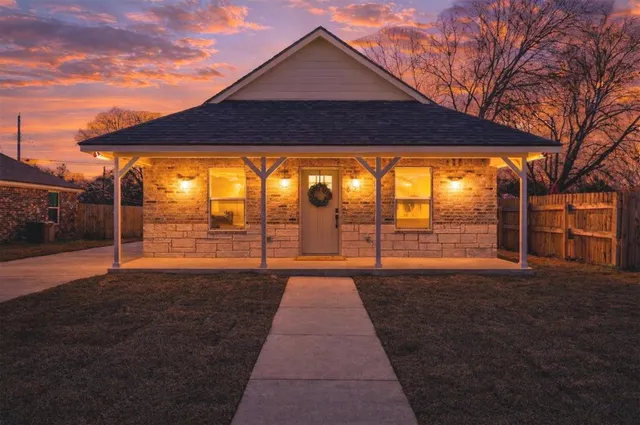 a backyard of a house with table and chairs