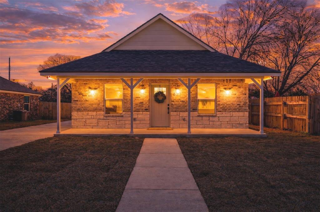 a backyard of a house with table and chairs
