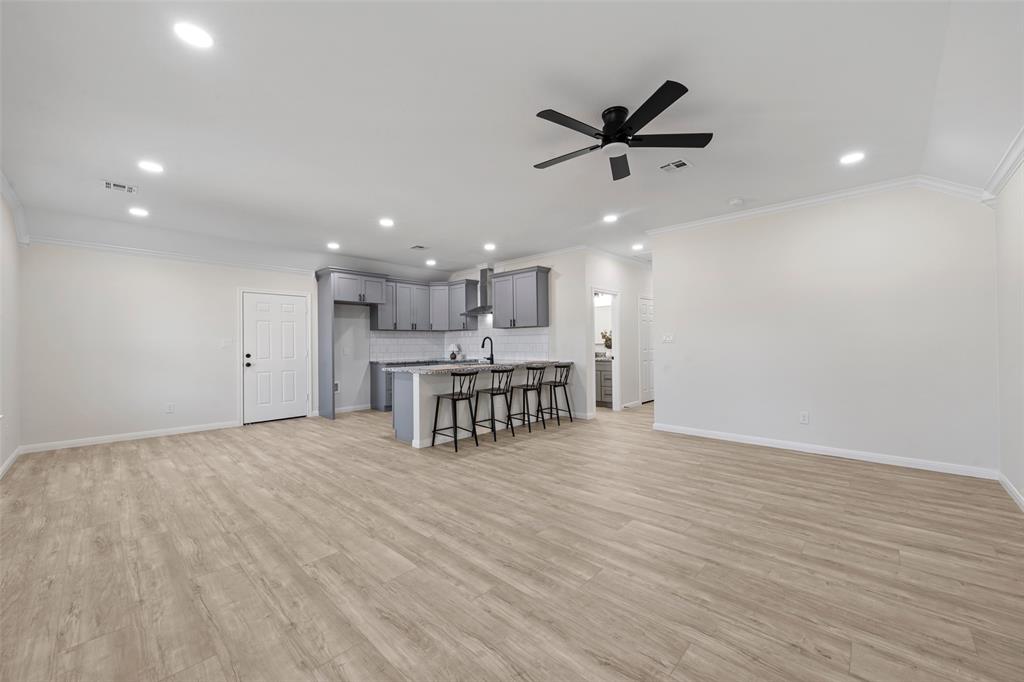 621 Delano Street Waco, TX 76704 - Photo 3 of 16 a view of an empty room with kitchen and window