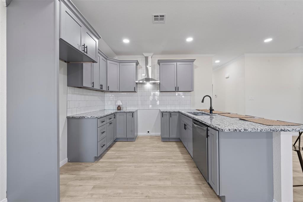 621 Delano Street Waco, TX 76704 - Photo 5 of 16 a large kitchen with stainless steel appliances granite countertop a sink and cabinets