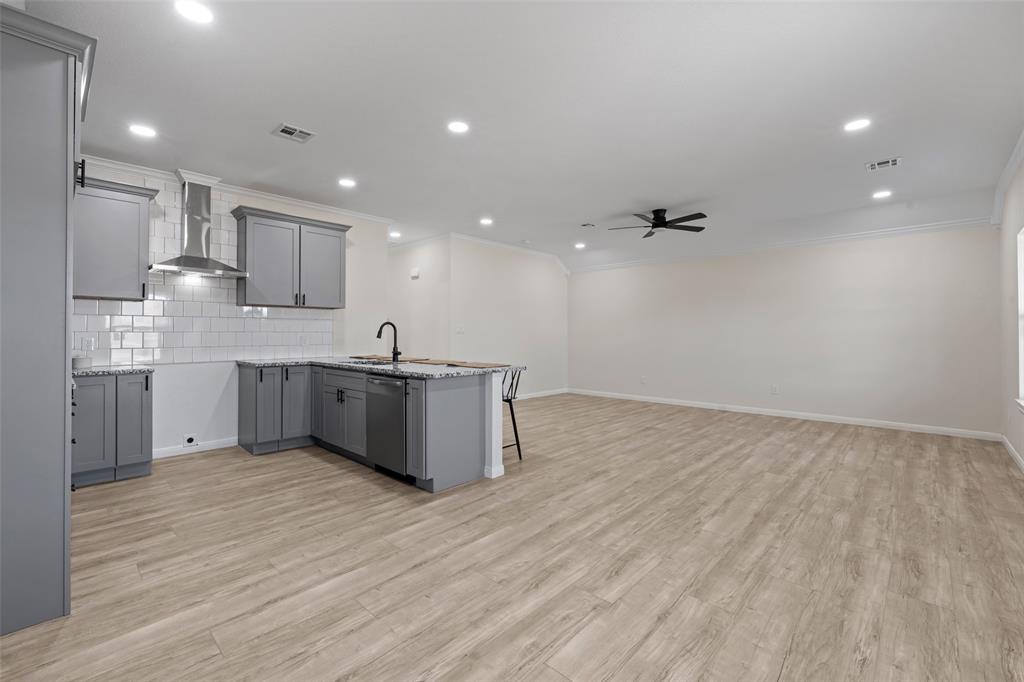 621 Delano Street Waco, TX 76704 - Photo 6 of 16 a large kitchen with stainless steel appliances a large counter top a stove and a refrigerator