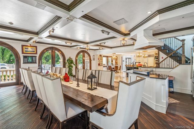 a dining room with furniture entryway and wooden floor
