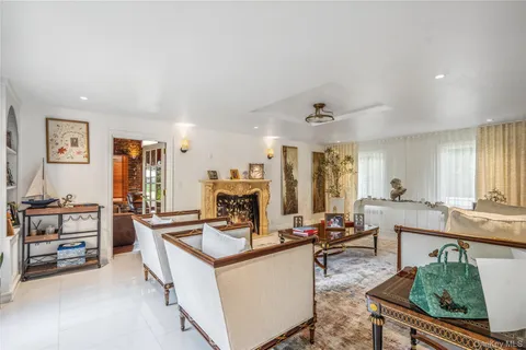 a room with stainless steel appliances kitchen island granite countertop a sink and cabinets