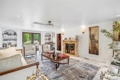 a living room with furniture a rug and a fireplace