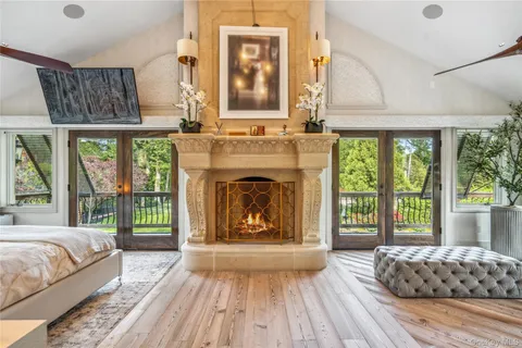 a bedroom with a bed and a fireplace