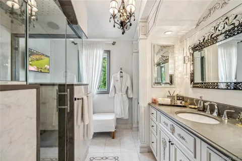 a spacious bathroom with a sink a mirror and a shower