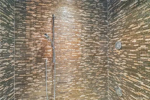 a bathroom with a brick wall