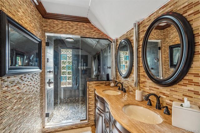 a bathroom with a sink a mirror and a shower