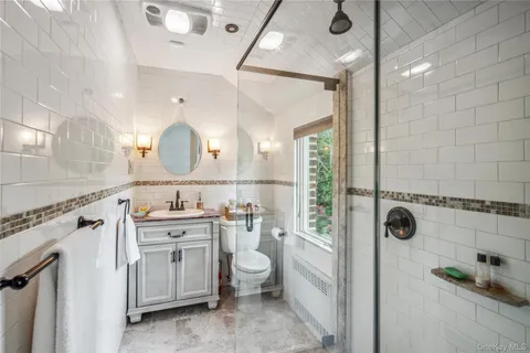 a bathroom with a granite countertop sink a toilet and a mirror