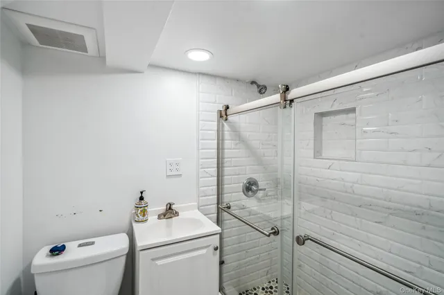 a bathroom with a sink toilet and shower