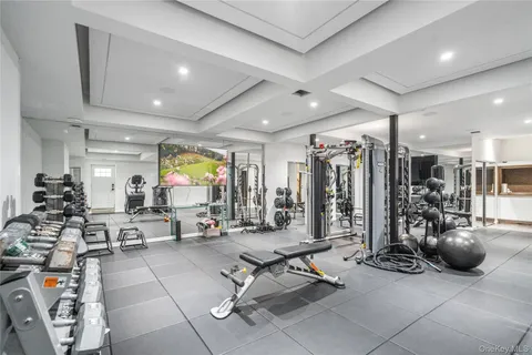 a living room with lots of gym equipment