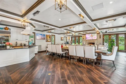 a living room with lots of furniture hardwood floor and a table
