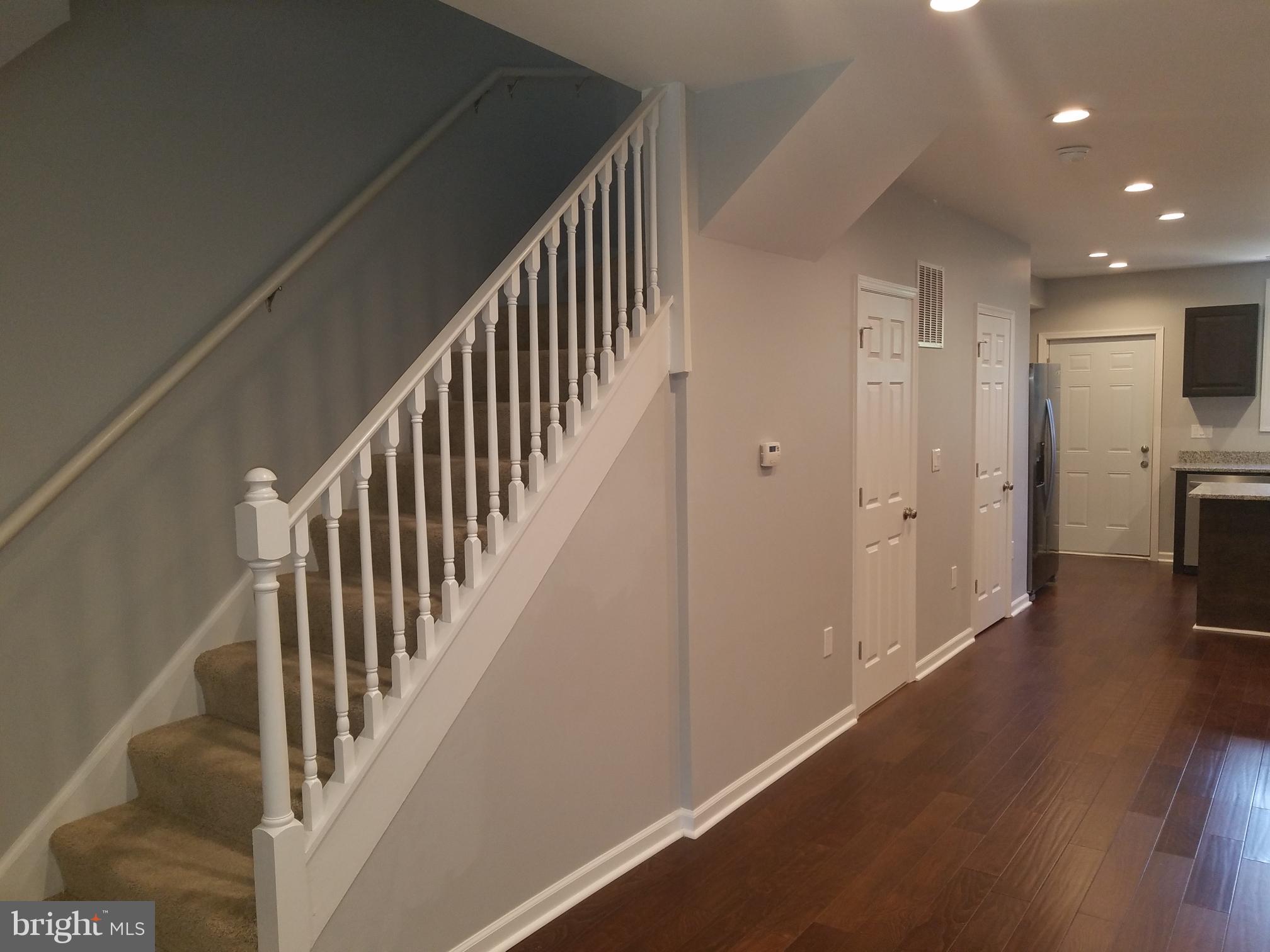 1322 Ridge Place Southeast Washington, DC 20020 - Photo 19 of 23 a view of a hallway with wooden floor and staircase
