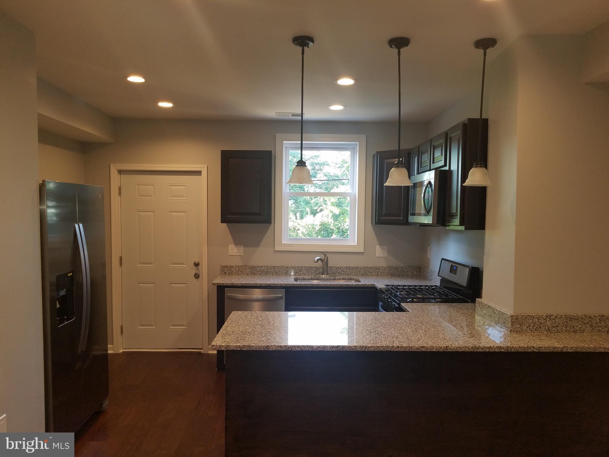 1322 Ridge Place Southeast Washington, DC 20020 - Photo 7 of 23 a kitchen with refrigerator and window