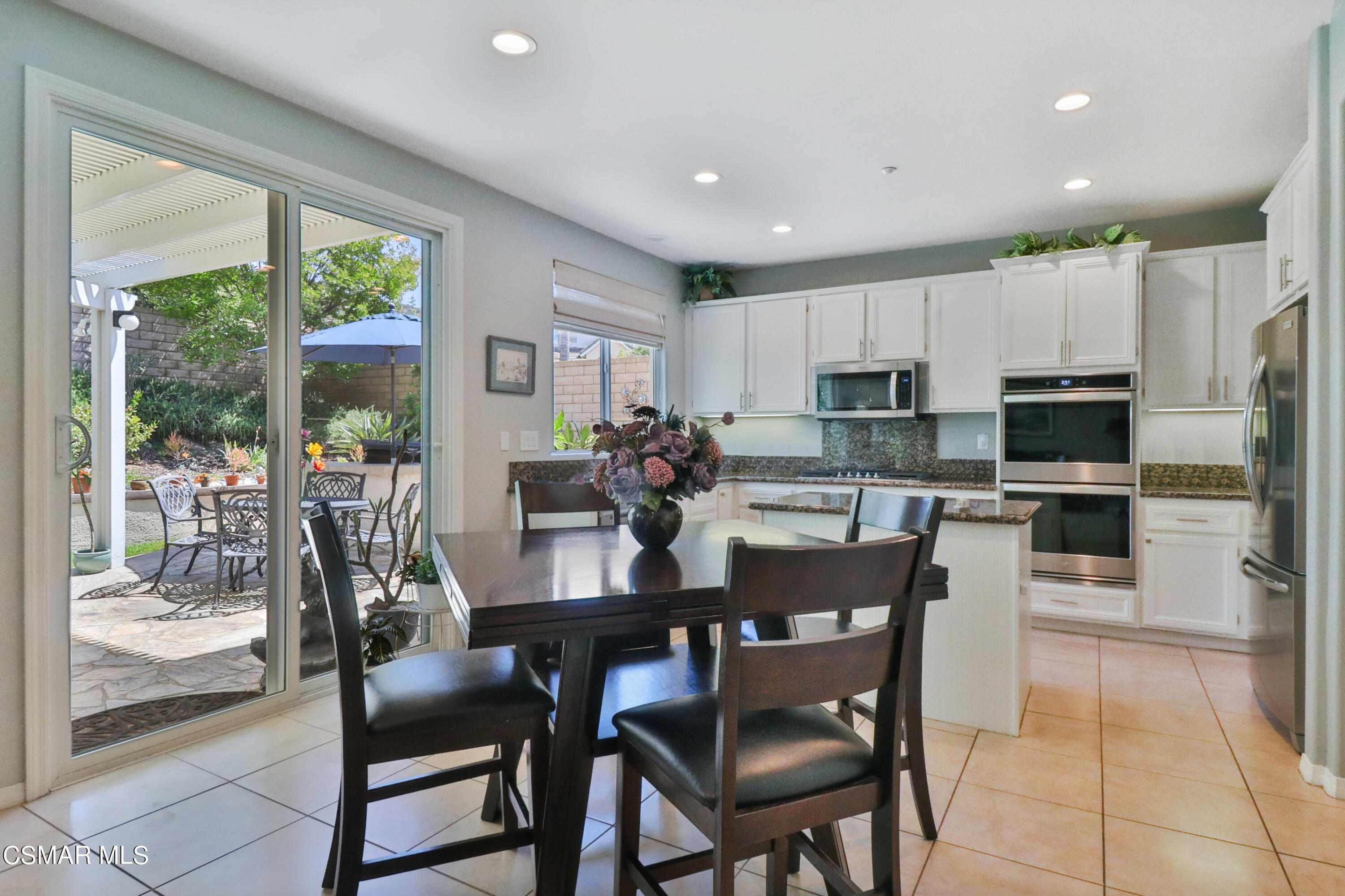 1419 Hidden Ranch Drive Simi Valley, CA 93063 - Photo 18 of 50 a dining room with kitchen island furniture a large window and a kitchen view