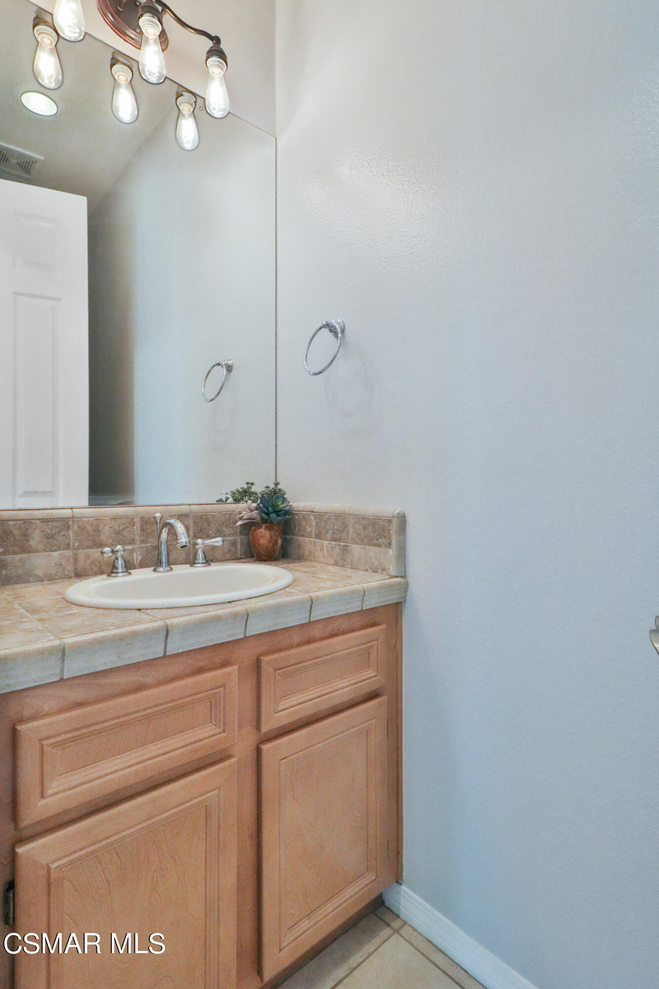 1419 Hidden Ranch Drive Simi Valley, CA 93063 - Photo 20 of 50 a bathroom with a granite countertop sink and a mirror