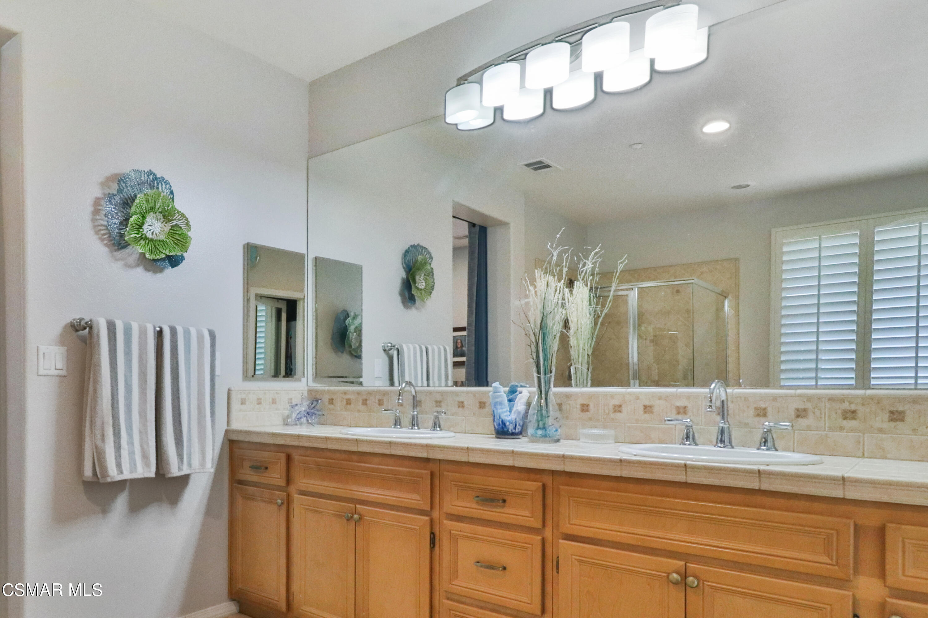 1419 Hidden Ranch Drive Simi Valley, CA 93063 - Photo 34 of 50 a bathroom with a double vanity sink and a mirror