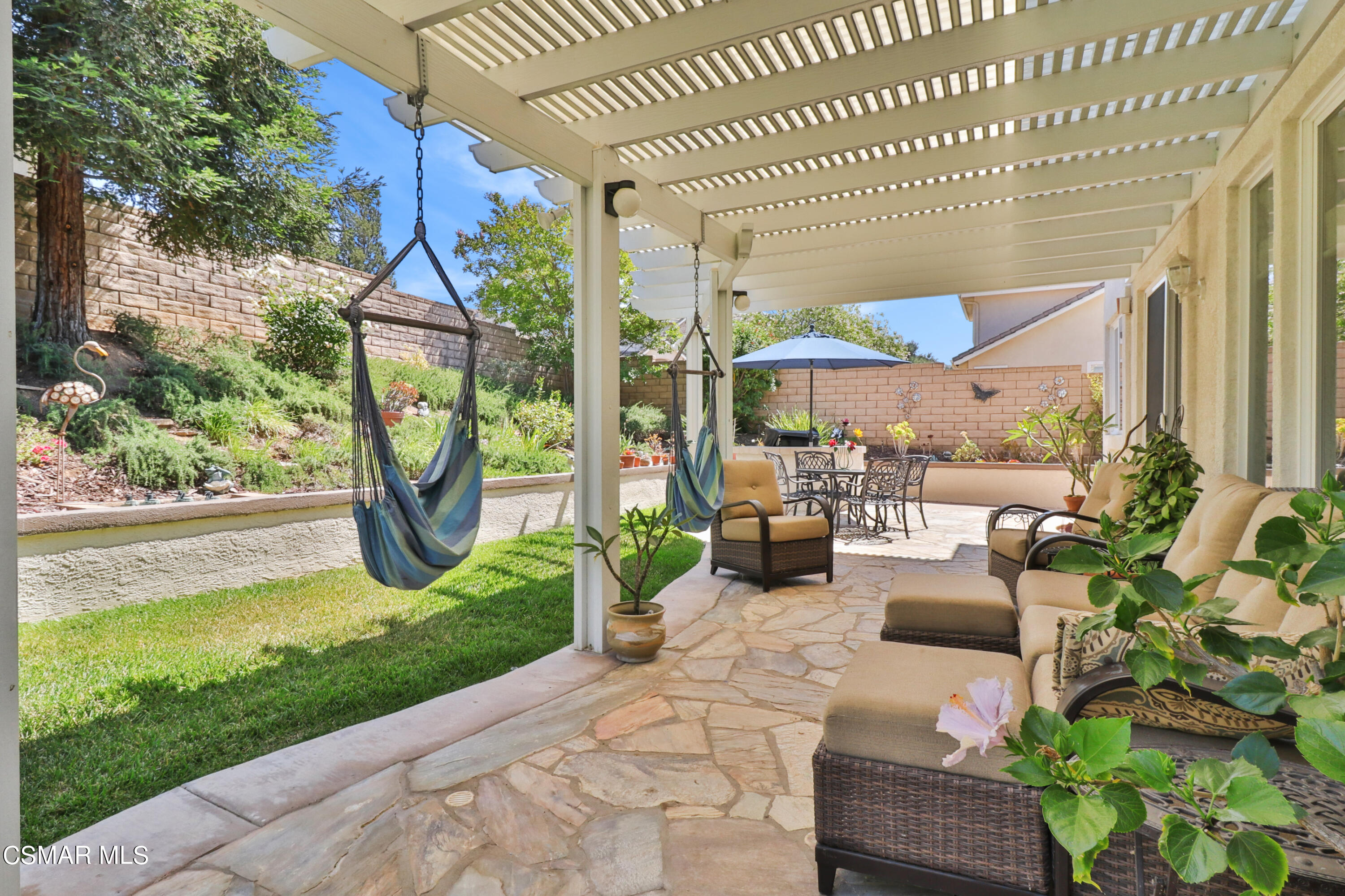 1419 Hidden Ranch Drive Simi Valley, CA 93063 - Photo 37 of 50 a view of a patio with couches table and chairs with potted plants and a patio