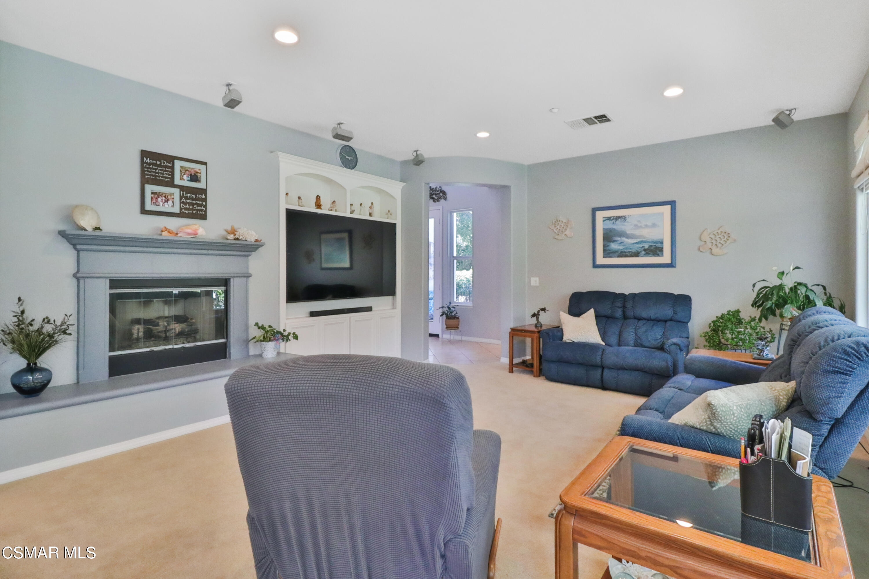1419 Hidden Ranch Drive Simi Valley, CA 93063 - Photo 10 of 50 a living room with furniture a flat screen tv and a fireplace