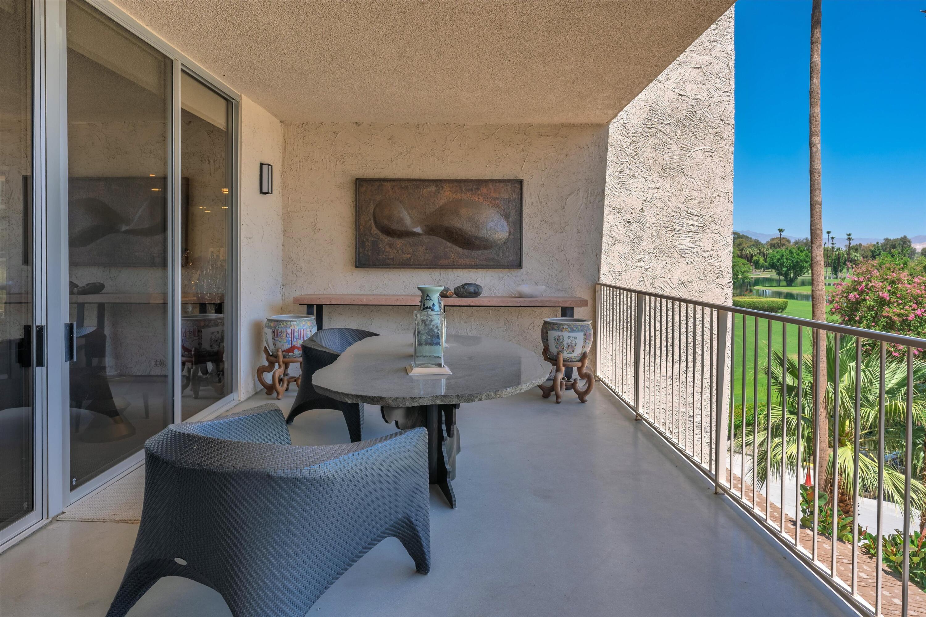 899 Island Drive, Unit 304 Rancho Mirage, CA 92270 - Photo 22 of 30 a living room with furniture and a flat screen tv
