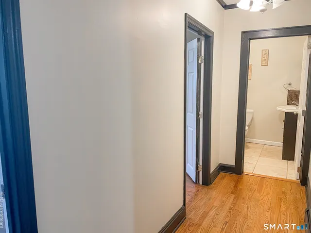 a view of a hallway with wooden floor