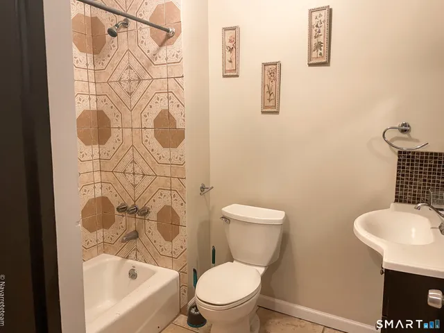 a white toilet sitting next to a bathroom sink