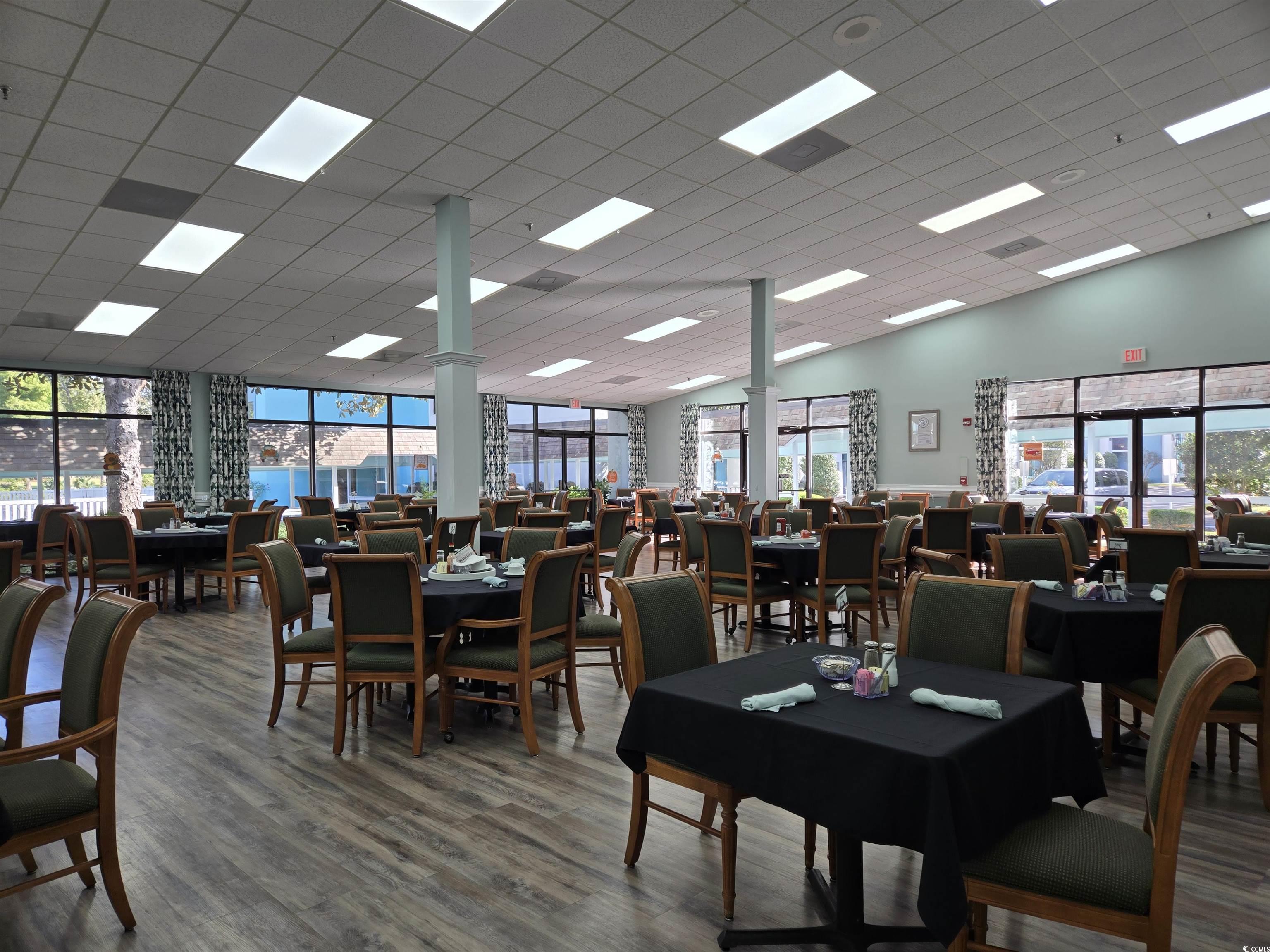5001 Little River Road, Unit E108 Myrtle Beach, SC 29577 - Photo 16 of 25 Dining space featuring plenty of natural light, wood finished floors, and a drop ceiling