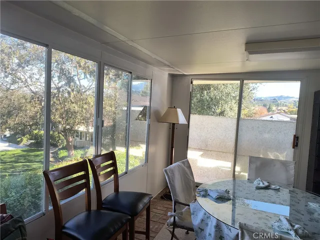 a view of a room with furniture and wooden floor