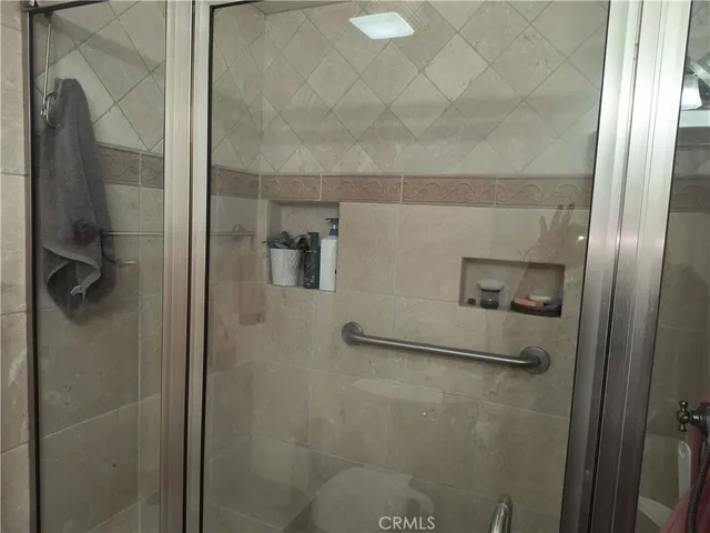 a bathroom with a glass shower door
