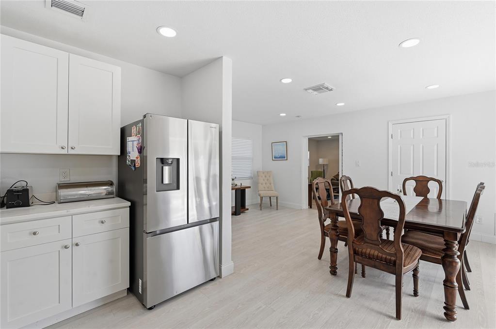 1946 Strathaven Road Winter Park, FL 32792 - Photo 7 of 37 a kitchen with stainless steel appliances a refrigerator a table and chairs