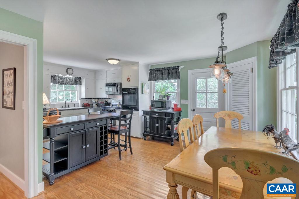 635 Greenwood Road Greenwood, VA 22943 - Photo 24 of 61 a large kitchen with kitchen island a stove a sink a dining table and chairs
