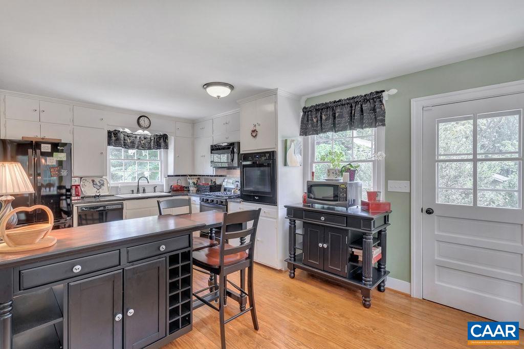 635 Greenwood Road Greenwood, VA 22943 - Photo 26 of 61 a room with stainless steel appliances kitchen island granite countertop a table chairs in it and a window