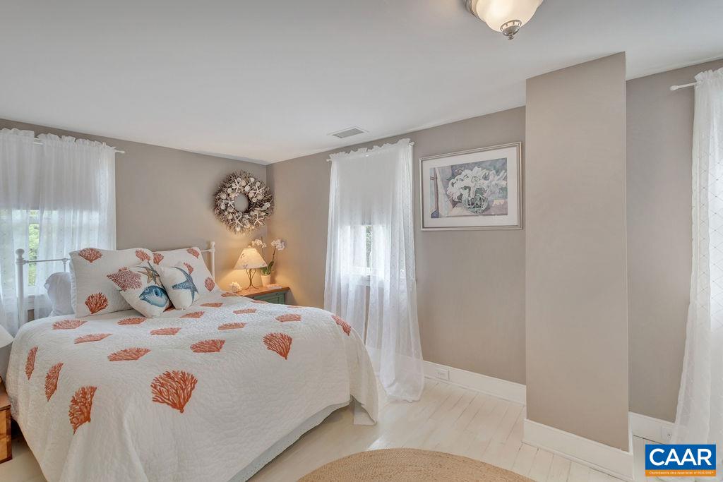 635 Greenwood Road Greenwood, VA 22943 - Photo 38 of 61 a bedroom with a bed and a painting on the wall