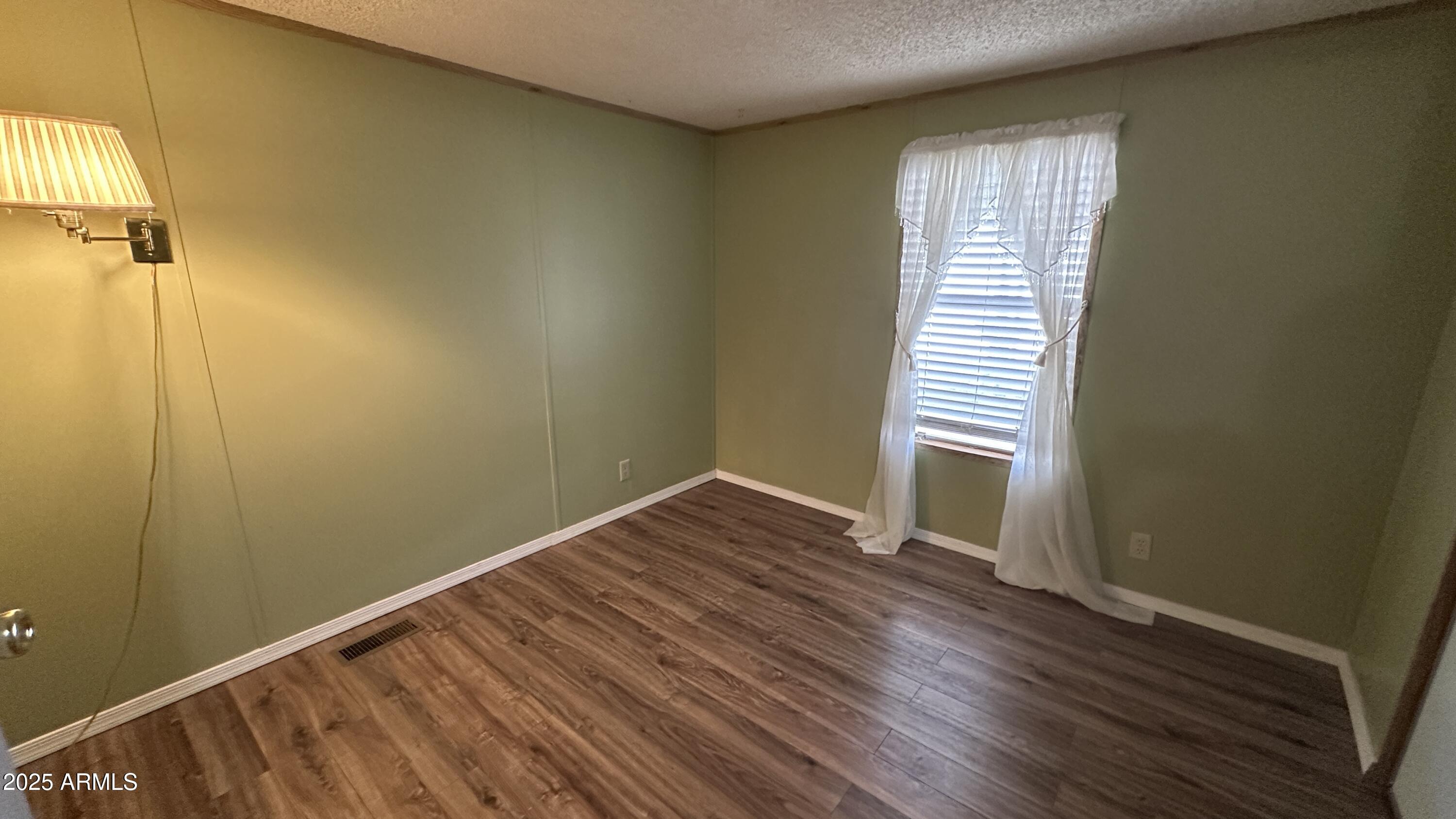 834 South Meridian Road, Unit 105 Apache Junction, AZ 85120 - Photo 18 of 48 a view of a room with wooden floor and windows