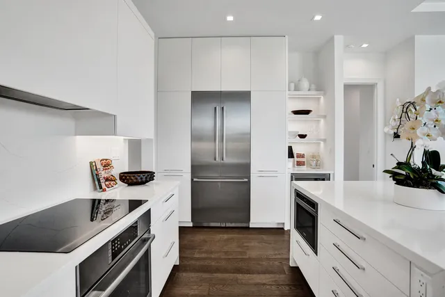 a kitchen with a stove a refrigerator and a sink