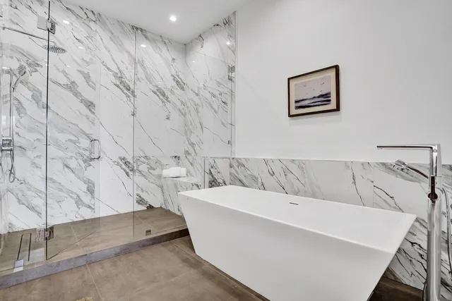 a bathroom with a bathtub and shower