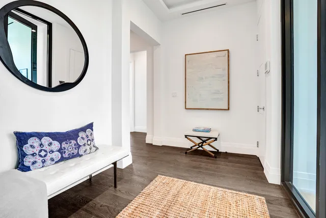 a living room with furniture and a mirror