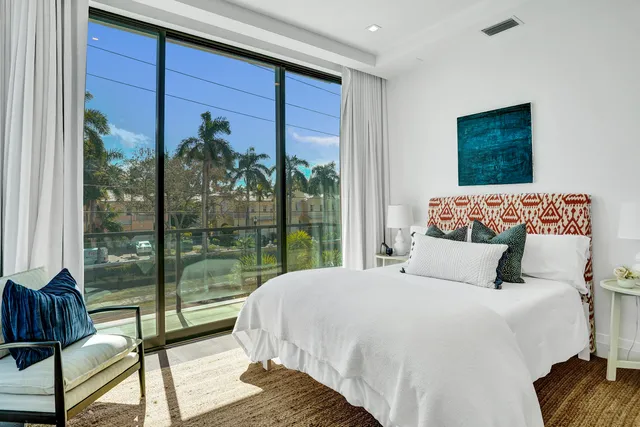 a bedroom with a large bed and a large window