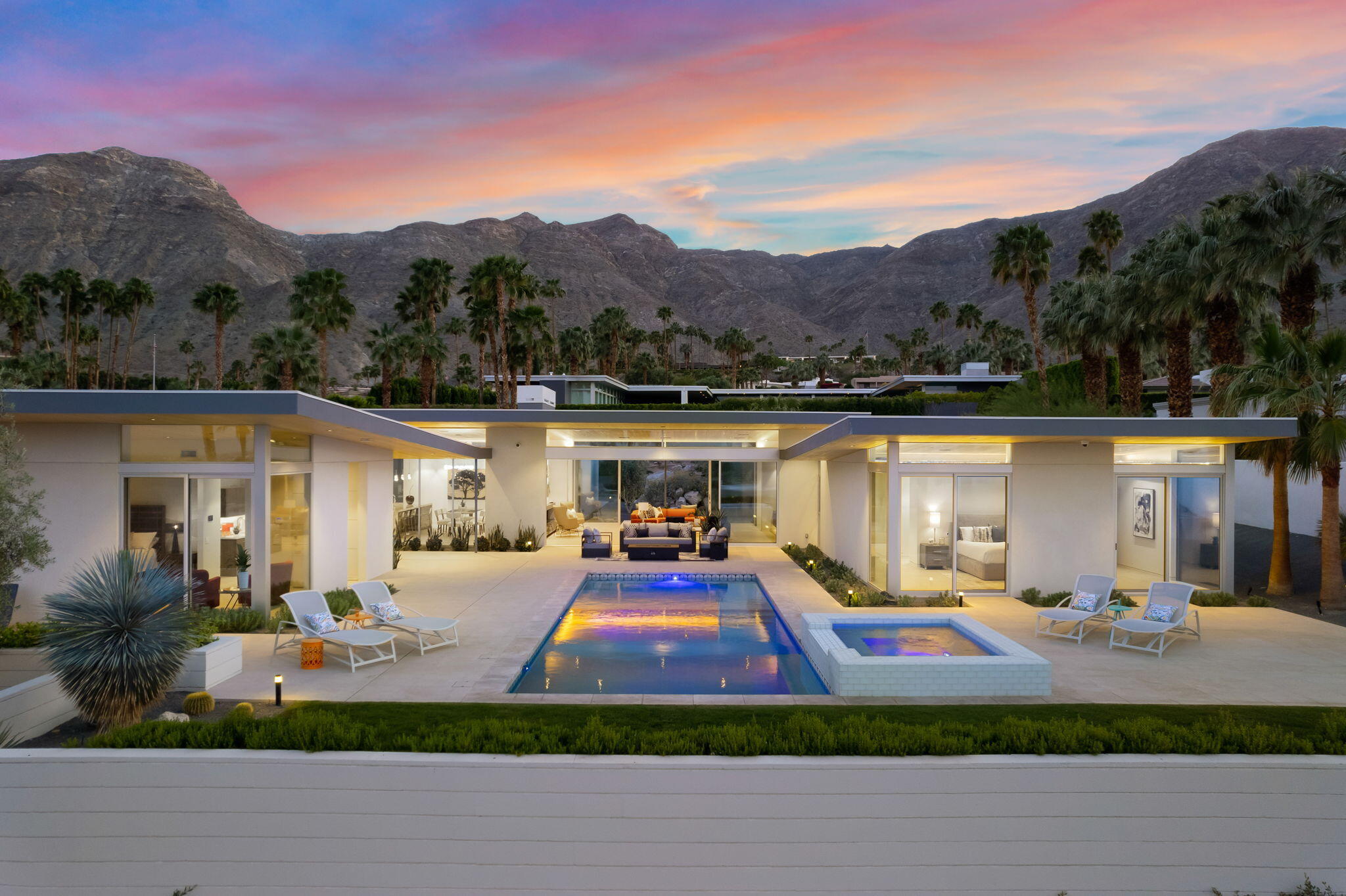 a front view of a house with a yard fire pit and outdoor seating