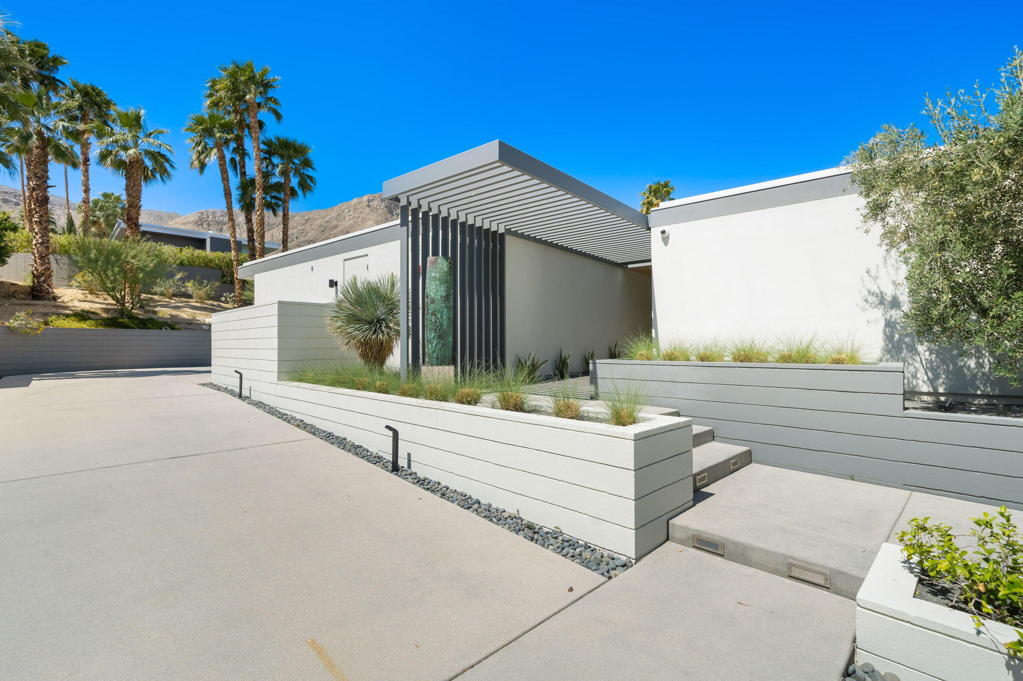 70263 Sonora Road Rancho Mirage, CA 92270 - Photo 9 of 98 a view of a house with a yard and potted plants