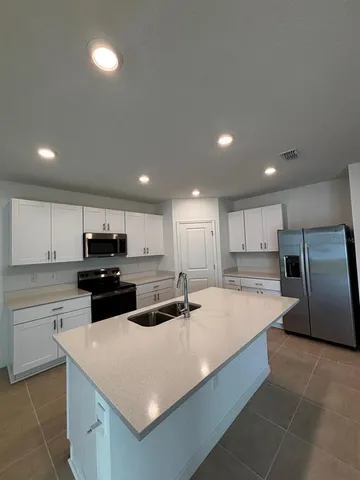 a bathroom with a double vanity sink and mirror