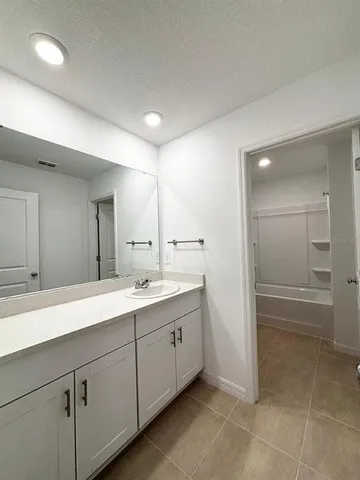 a view of kitchen with kitchen island white cabinets and appliances