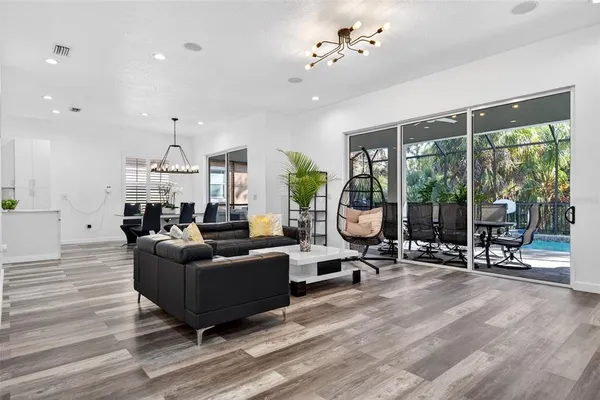 a large white kitchen with stainless steel appliances a stove a sink and a refrigerator