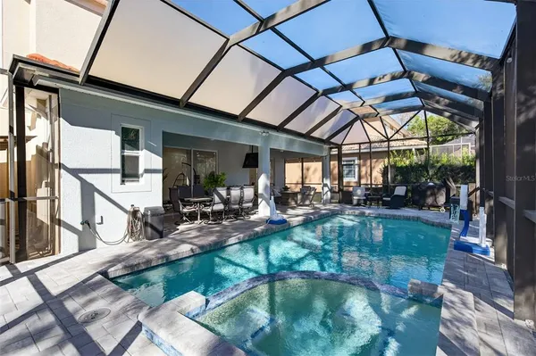 a view of a patio with a table chairs and a backyard
