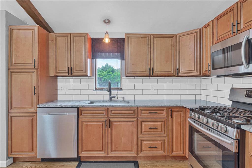 122 Fulton Road Canonsburg, PA 15317 - Photo 11 of 25 a kitchen with granite countertop wooden cabinets stainless steel appliances and a sink