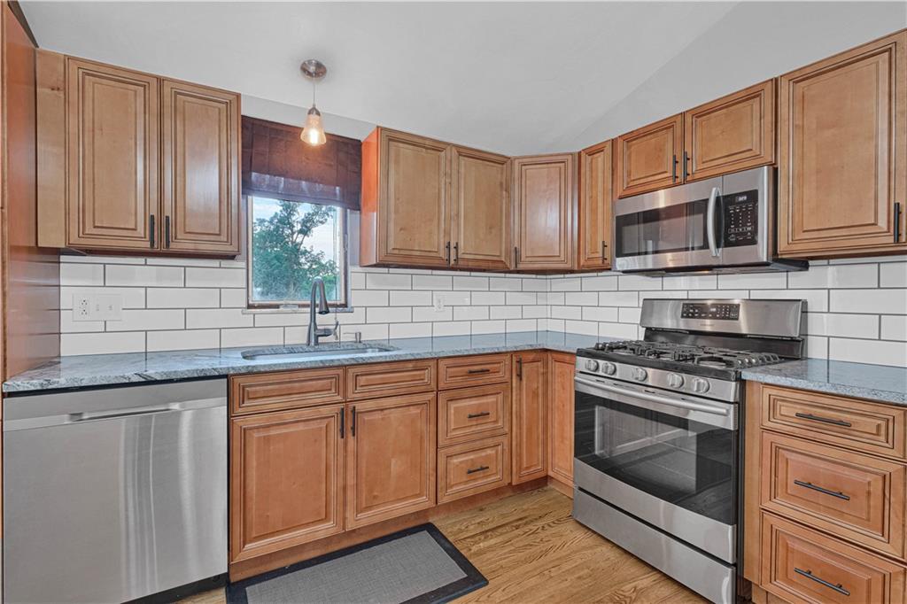 122 Fulton Road Canonsburg, PA 15317 - Photo 13 of 25 a kitchen with cabinets stainless steel appliances a sink and wooden floor