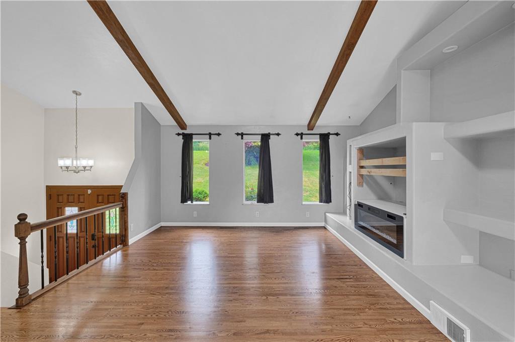 122 Fulton Road Canonsburg, PA 15317 - Photo 4 of 25 an empty room with wooden floor and fireplace
